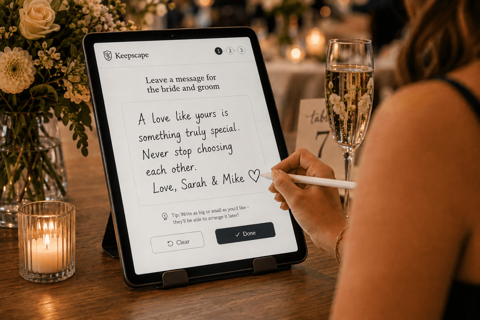 A guest writing a handwritten message on a tablet at a wedding celebration